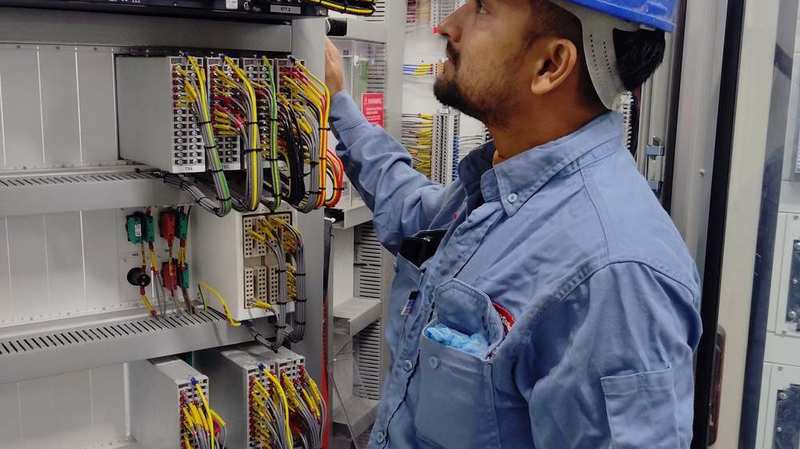 Electrician wiring a commercial control panel